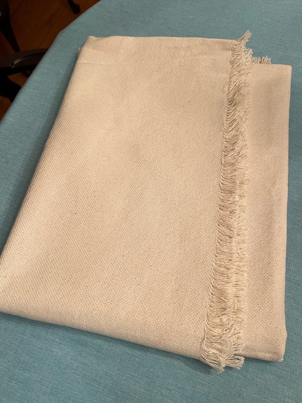 NWOT 52” x 70” light beige woven tablecloth with fringe